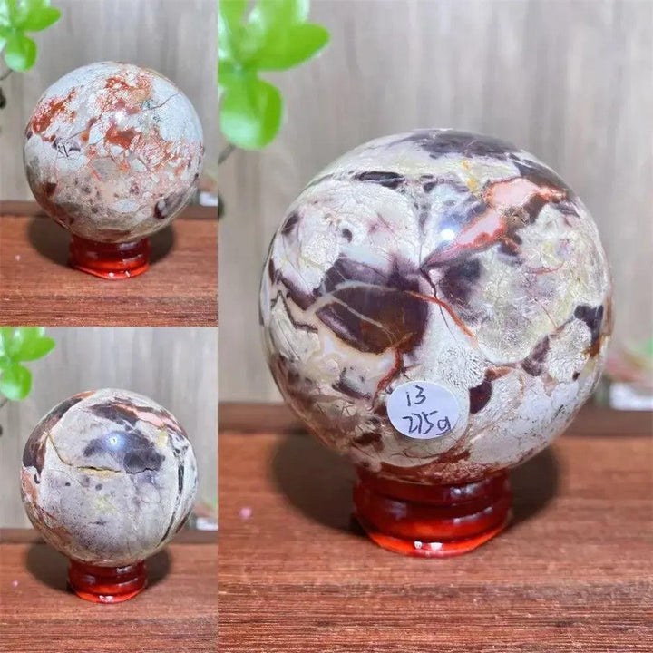 Polished Money Agate Crystal Sphere, a unique abundance stone with vibrant gold, rust, and cream banding on a red stand.