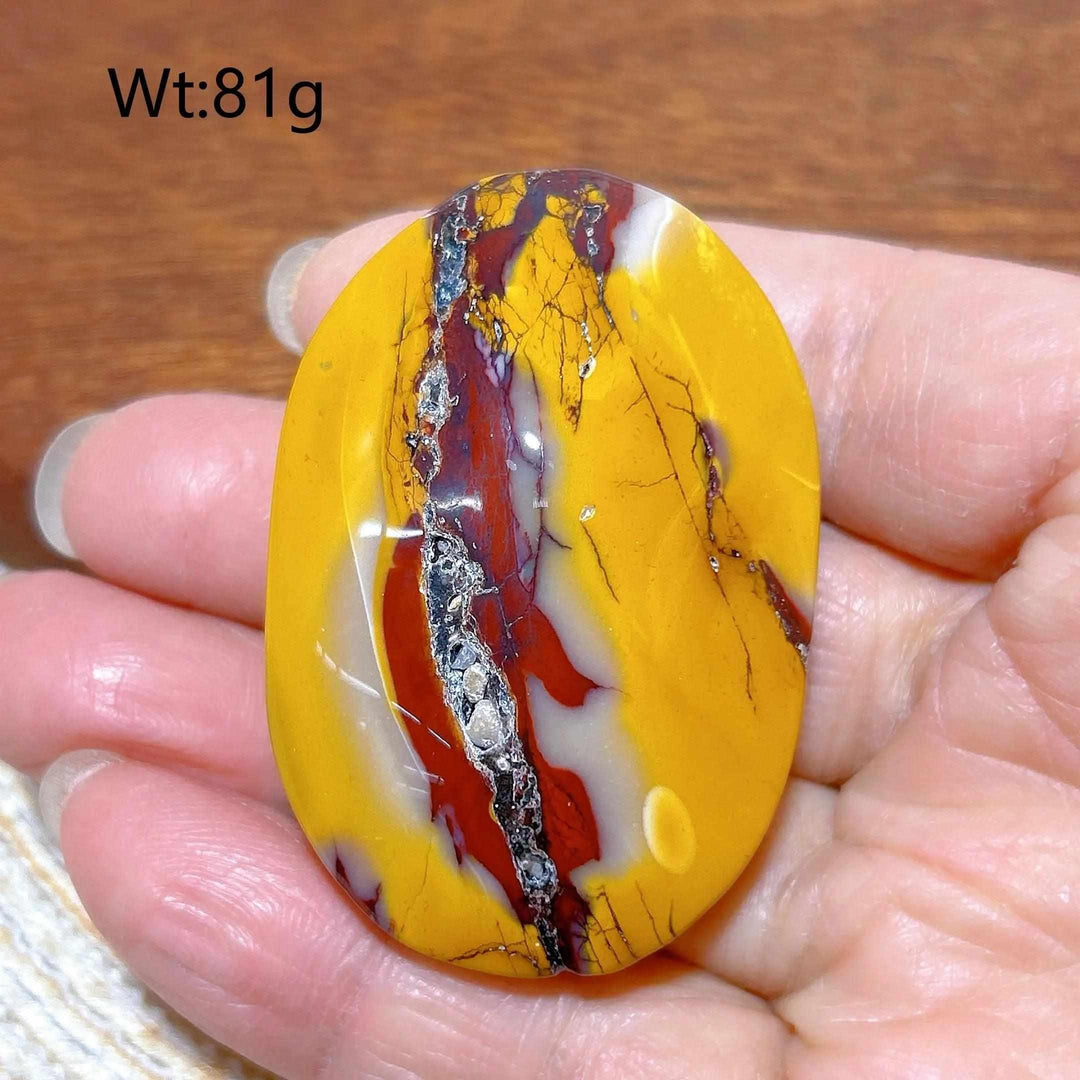 Smooth 81g Mookaite Jasper palm stone featuring vibrant red, yellow, and cream swirls for grounding and vitality.