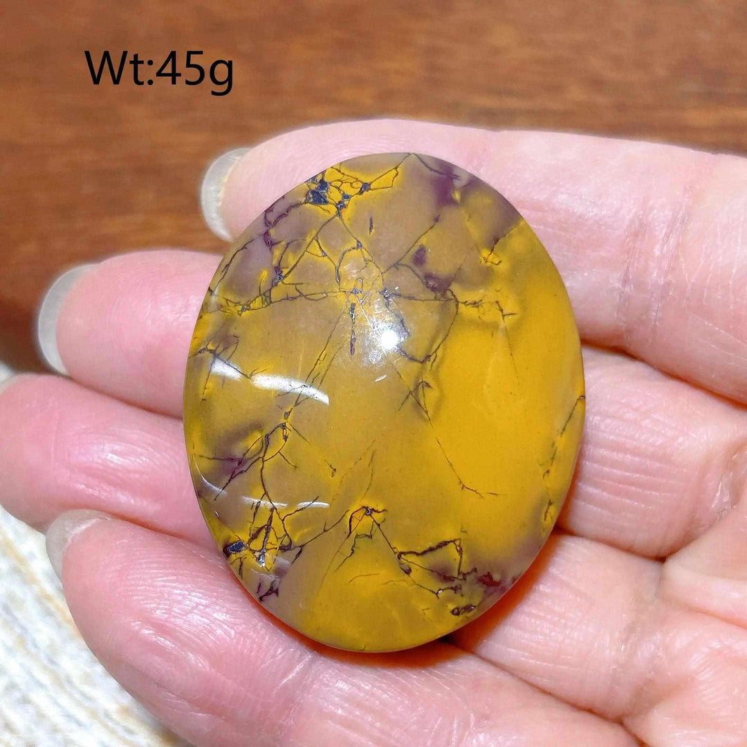 Smooth 45g Mookaite Jasper palm stone featuring earthy mustard, red, and cream swirls for grounding and vitality.