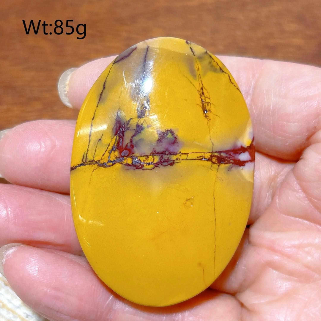 Smooth 85g Mookaite Jasper palm stone featuring vibrant mustard yellow and deep red swirls for grounding energy.