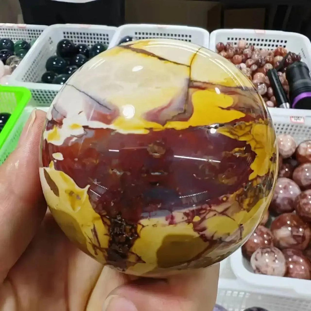 Hand-polished Mookaite Jasper sphere from Crystal Destiny, featuring earthy reds, creamy ivories, and sun-warmed golds.
