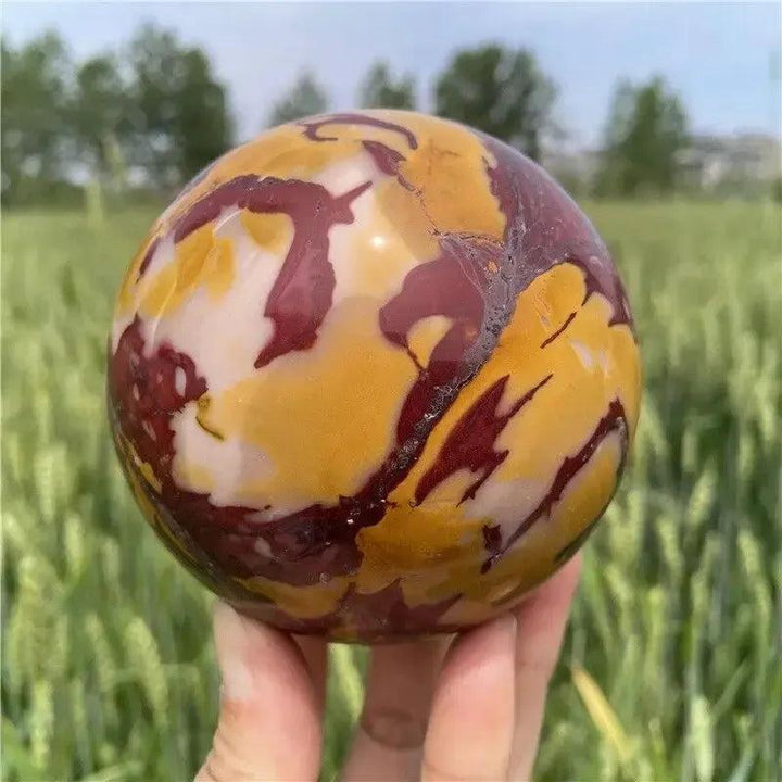 Hand-polished Mookaite Jasper sphere by Crystal Destiny, featuring earthy reds, creamy ivories, and sun-warmed golds.