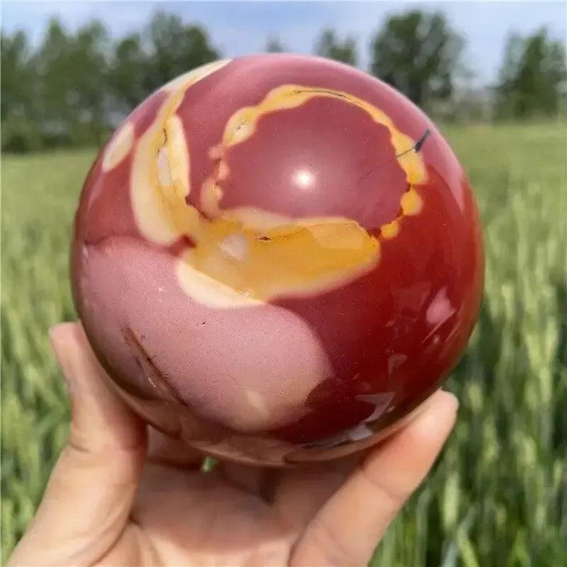 Hand-polished Mookaite Jasper sphere with earthy reds, creamy ivories, and sun-warmed golds from Crystal Destiny.