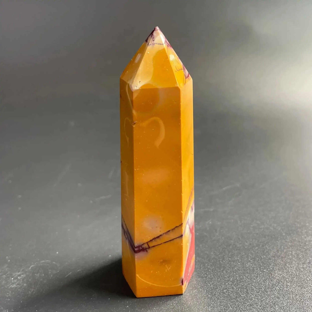 Polished Mookaite Jasper tower point featuring mustard yellow and red bands for grounding and focused intention.
