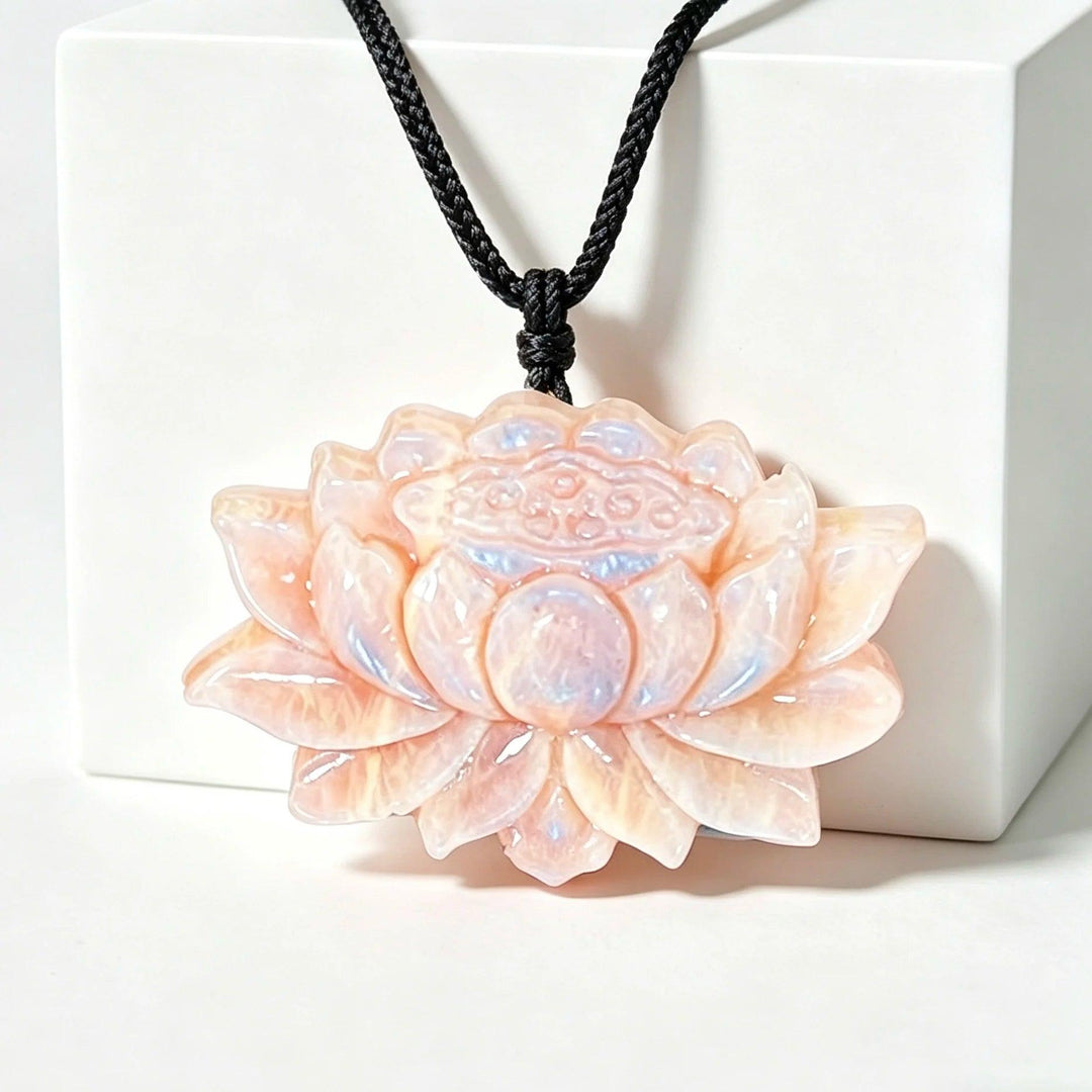 Luminous Moonstone Crystal Carved Lotus Flower pendant with a soft, iridescent glow for peace and intuition.