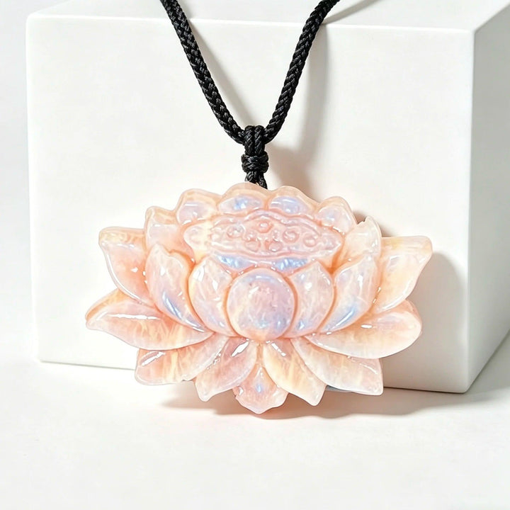 Luminous Moonstone Crystal Carved Lotus Flower pendant with a soft, iridescent glow for peace and intuition.