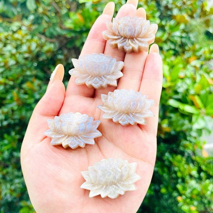 Hand held Moonstone crystal lotus flower carvings with a luminous adularescent glow for peace and intuition.