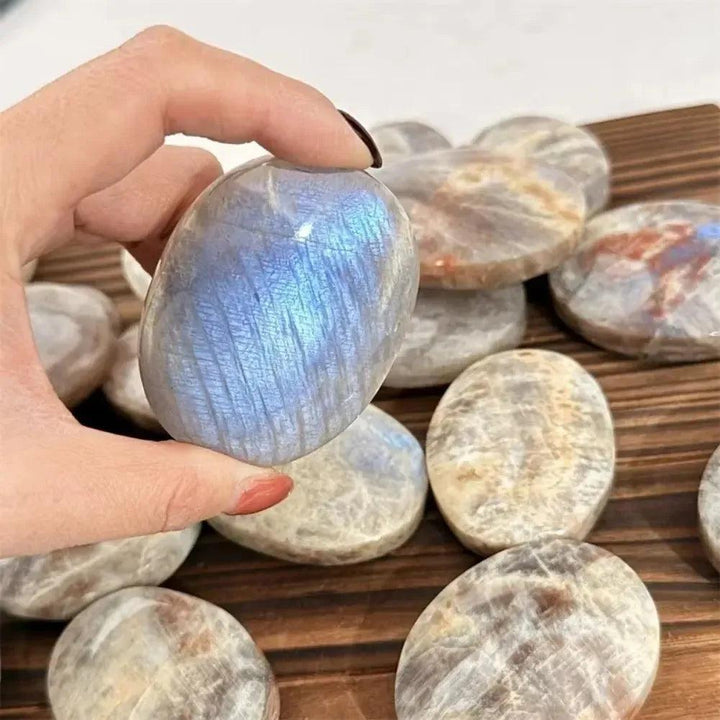 Hand-polished natural blue flash moonstone palm stone with a smooth, healing crystal surface perfect for meditation.