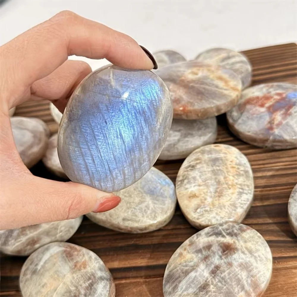 Hand-polished natural blue flash moonstone palm stone with a smooth, healing crystal surface perfect for meditation.