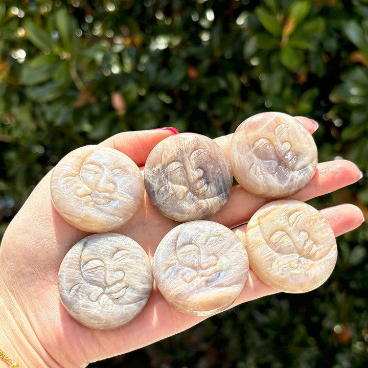 Moonstone Crystal Sun and Moon Face Carving, pearlescent glow, symbolizing intuition and new beginnings.