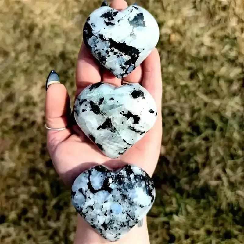 Polished black moonstone heart carvings for reiki healing, featuring natural crystal patterns in a smooth, handheld design.