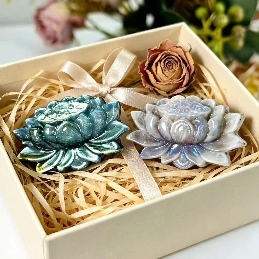 Iridescent Moonstone and Labradorite crystal carved lotus flowers, symbolizing transformation, nestled in a gift box.