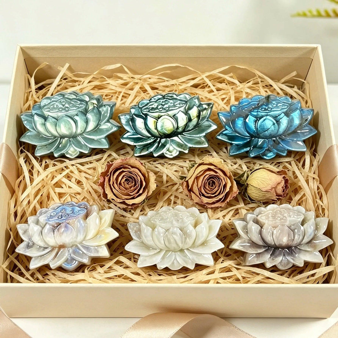 Moonstone and Labradorite crystal carved lotus flowers, symbolizing transformation and intuition, nestled in a gift box.