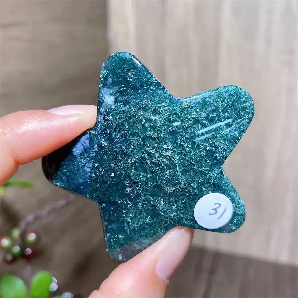 Hand-carved moss agate star crystal carving with deep green inclusions, a natural healing stone for new beginnings.