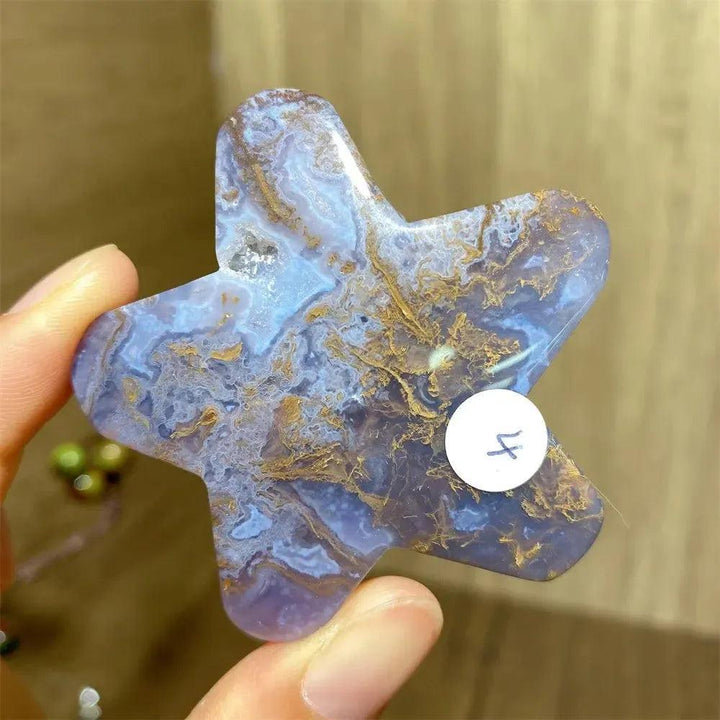 Hand-carved blue and gold moss agate star crystal carving, a natural healing stone for new beginnings.