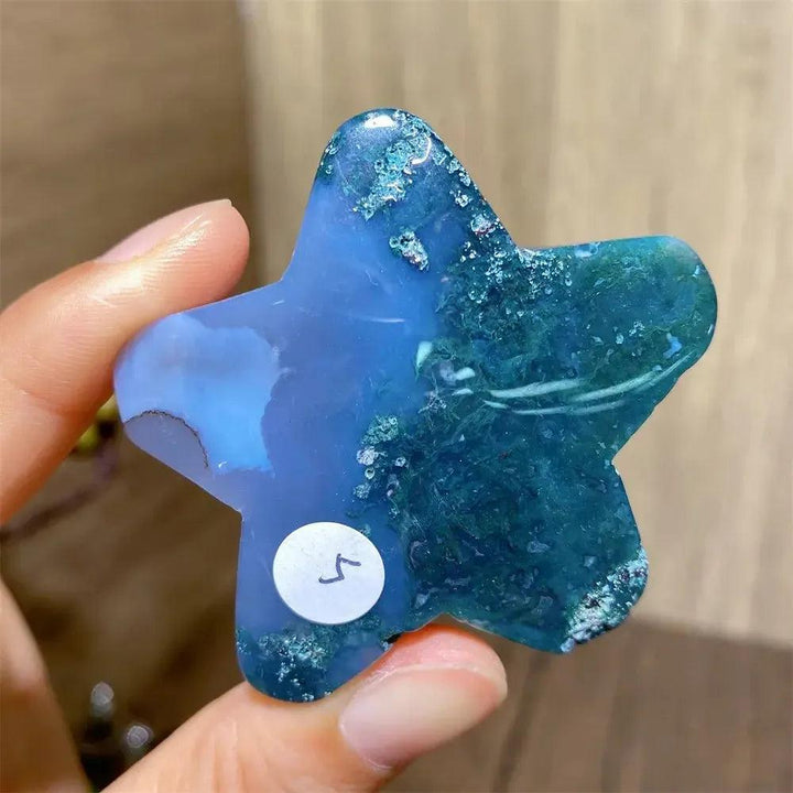 Hand-carved blue and green moss agate star crystal, a natural healing stone for new beginnings and abundance.