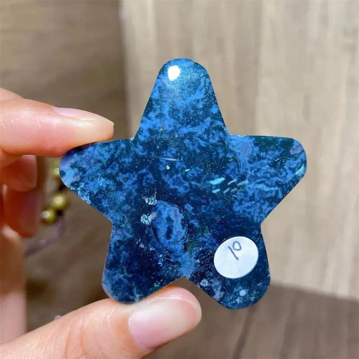 Hand-carved blue moss agate star crystal, a nurturing stone for new beginnings and prosperity.