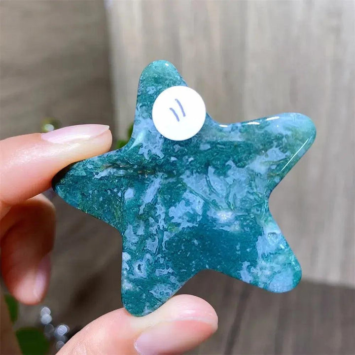 Hand-carved moss agate star crystal carving, showcasing deep green inclusions for new beginnings and abundance.