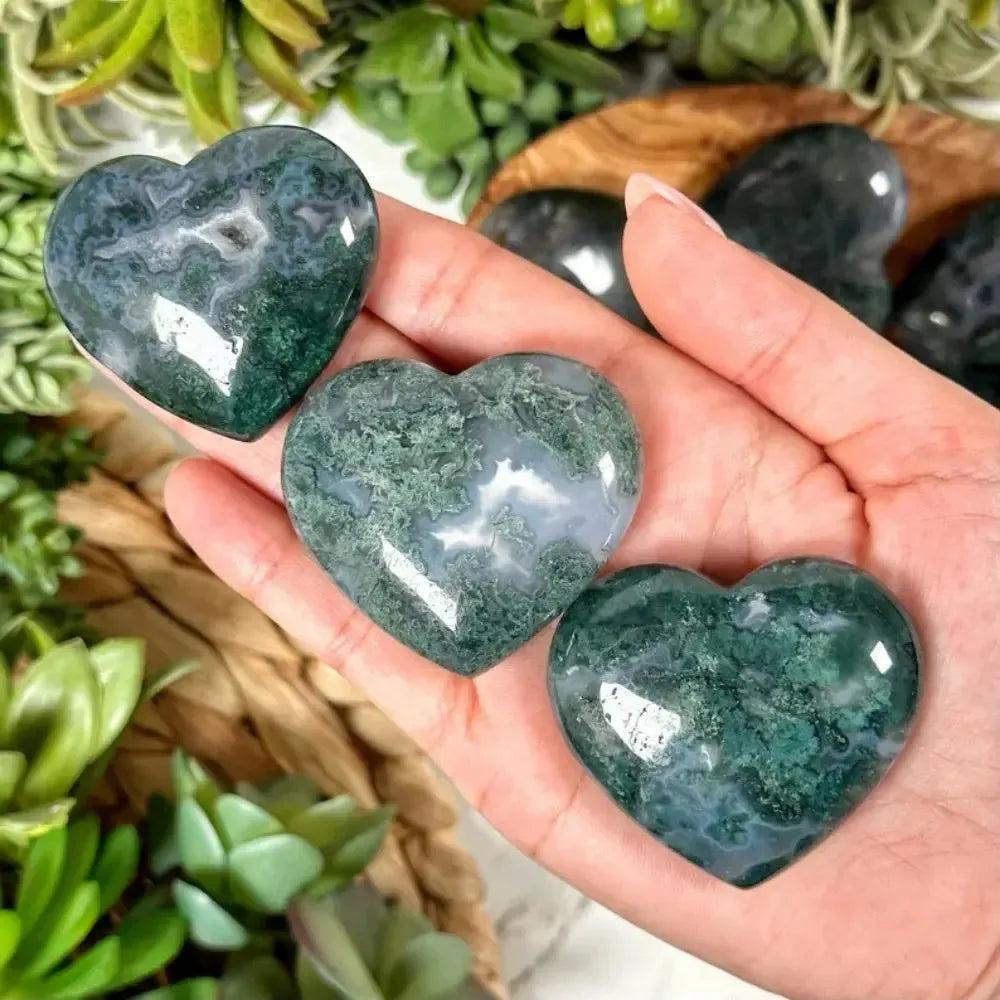 Crystal Destiny's Moss Agate crystal hearts with green inclusions, promoting growth and abundance.