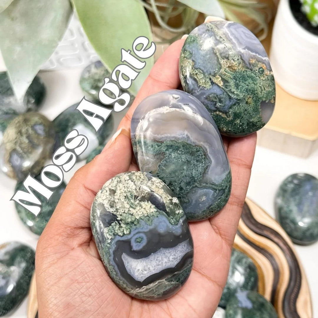 Hand-held Moss Agate palm stones with translucent white chalcedony and moss-like green mineral inclusions for grounding.