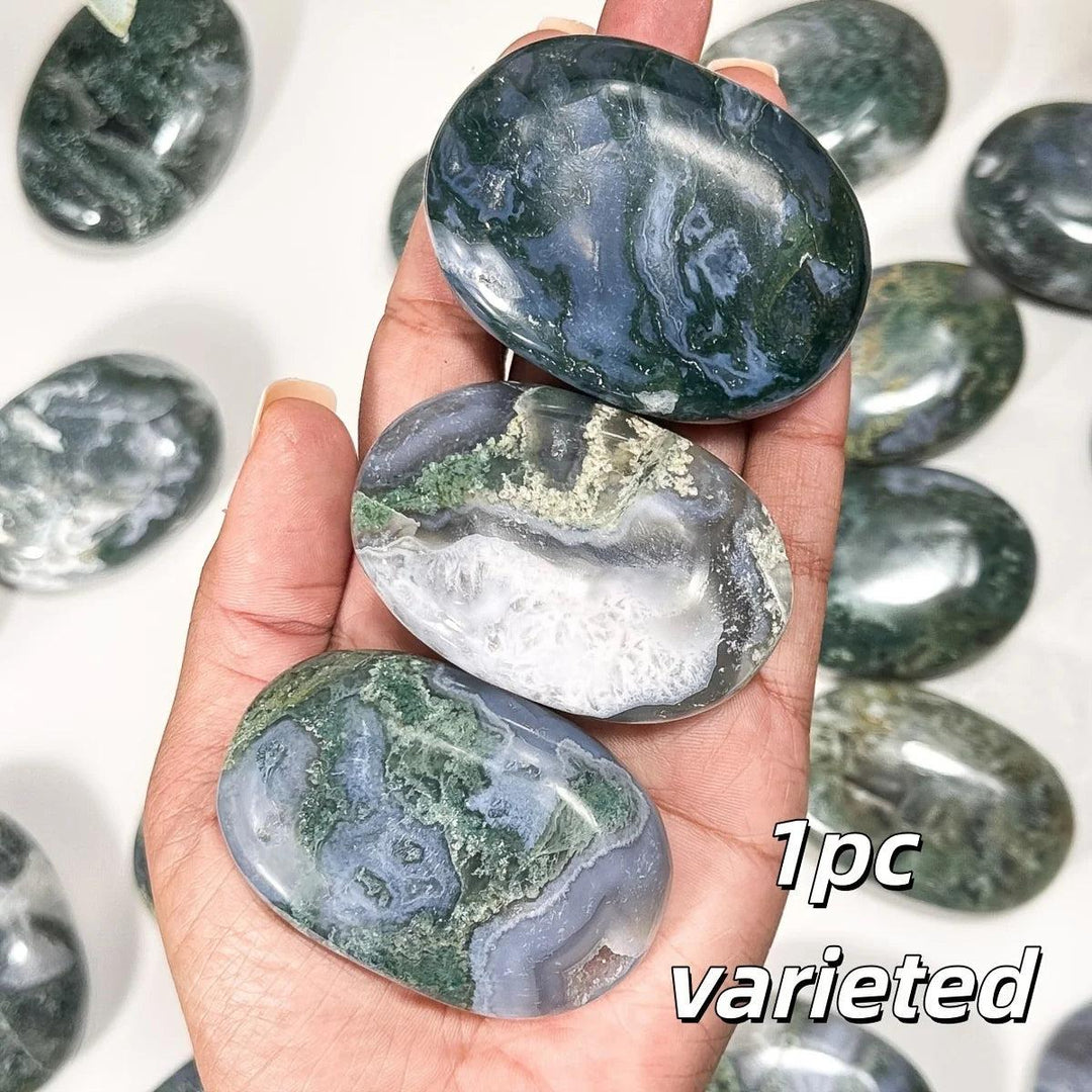 Smooth, polished Moss Agate palm stone with green moss-like inclusions for grounding and heart chakra healing.
