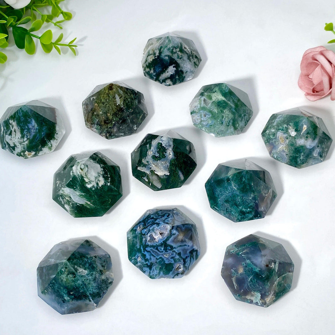 Polished Moss Agate crystals in various diamond shapes, showcasing green inclusions for growth and abundance.