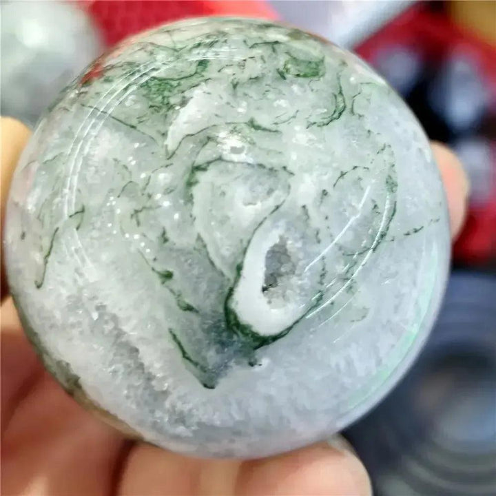 Moss Agate Sphere: Translucent chalcedony with vibrant green moss-like inclusions, hand-polished to a glassy finish.