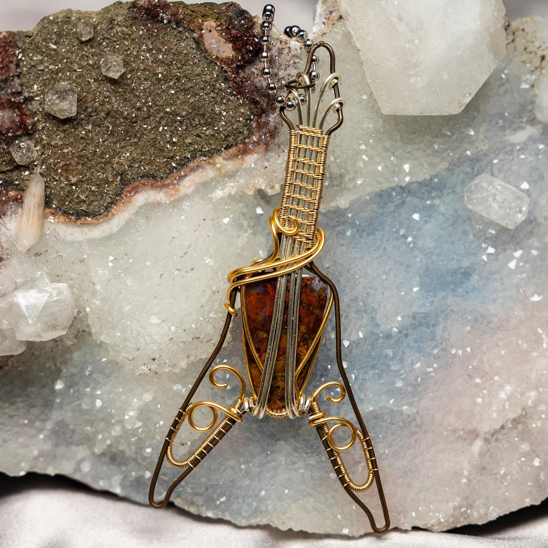 Handcrafted Moss Agate Guitar Wire Wrap Pendant: copper and gold wire forms a guitar around a unique green moss agate stone.