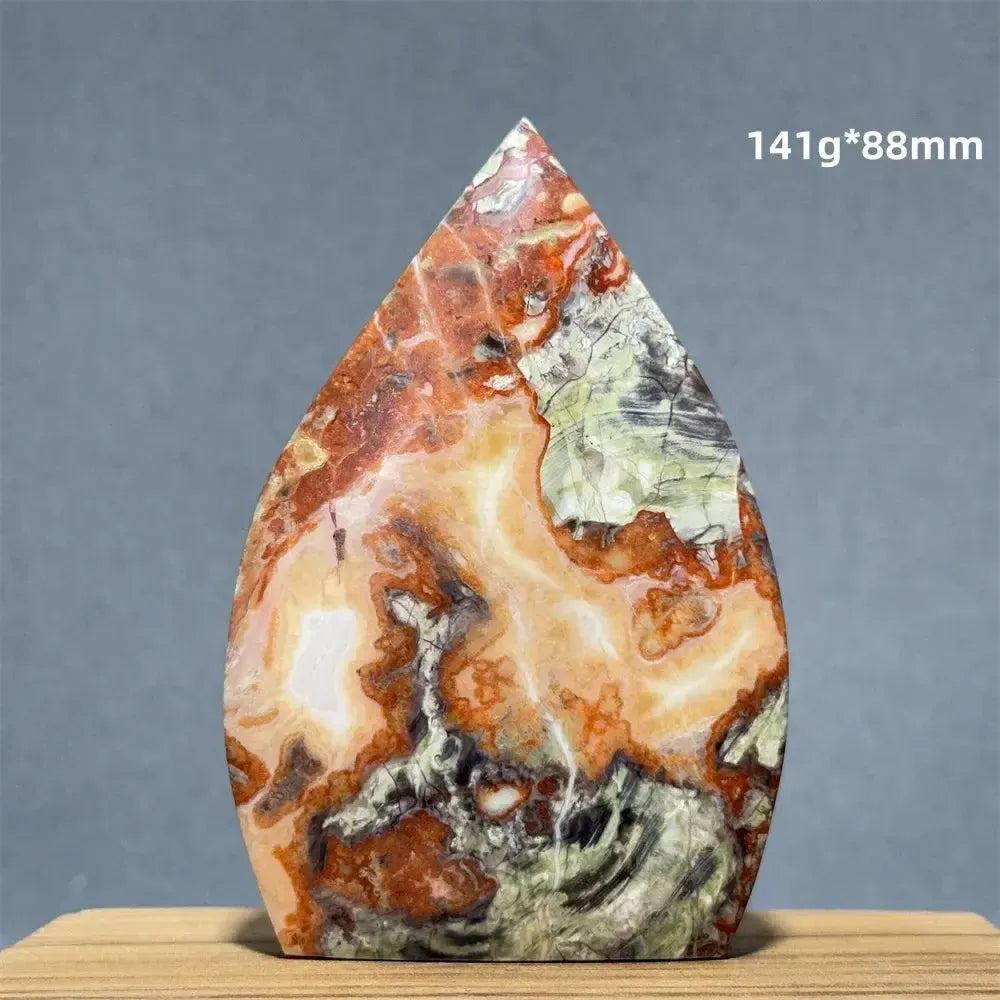 Moss Agate freeform torch from Crystal Destiny, featuring vibrant orange, green, and white natural patterns.