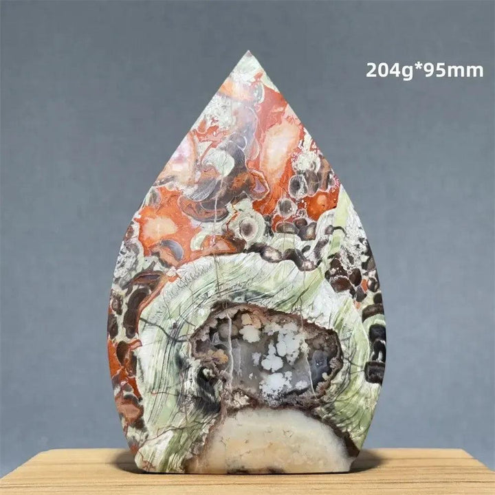 Natural Moss Agate freeform torch from Crystal Destiny, featuring green, red, and white dendritic inclusions with a geode cavity.