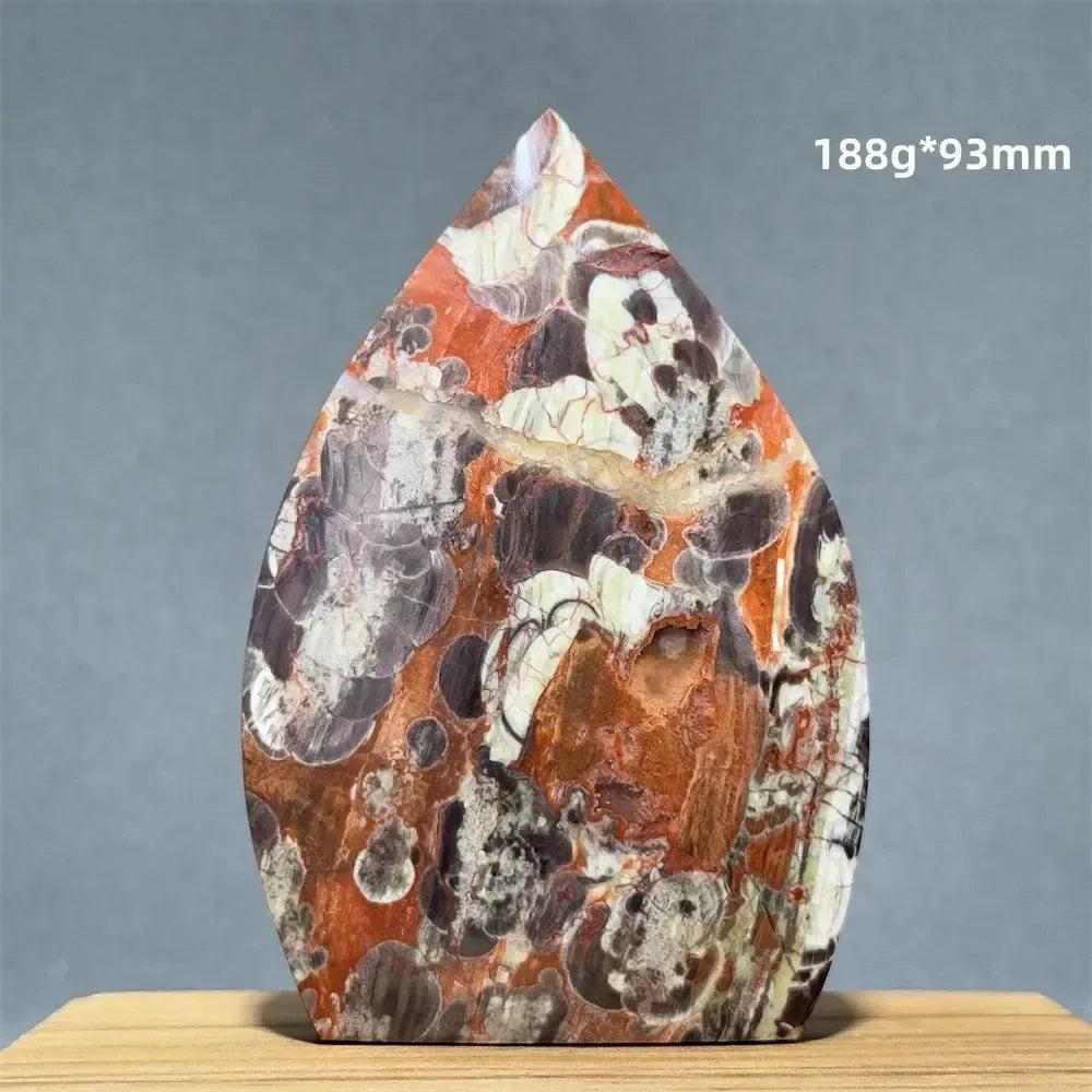Red and white freeform torch-shaped natural mineral specimen with dark inclusions from Crystal Destiny.