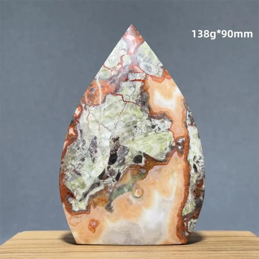 Moss Agate freeform torch from Crystal Destiny, featuring green, orange, and white dendritic patterns.