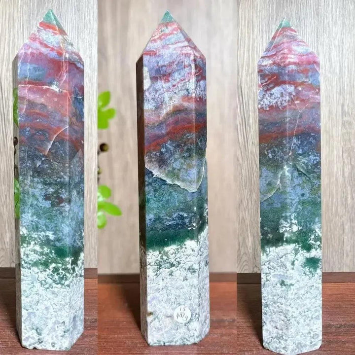 Moss Agate Ocean Jasper Crystal Tower: Polished, tall crystal with vibrant red, green, blue, and white inclusions.