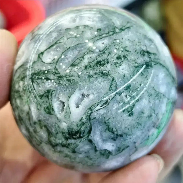 Polished Moss Agate sphere from Crystal Destiny, featuring green dendritic inclusions and white chalcedony.