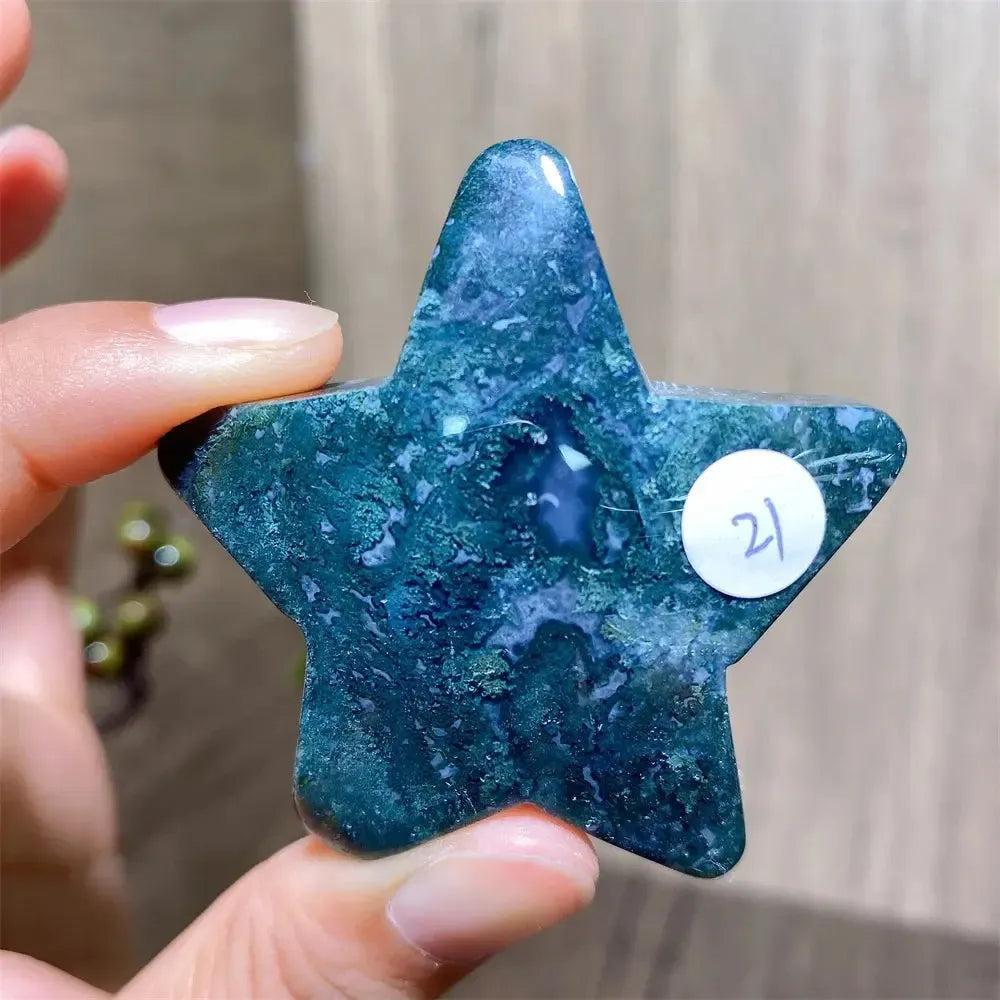 Hand-carved green moss agate star crystal from Crystal Destiny, showing unique dark inclusions.