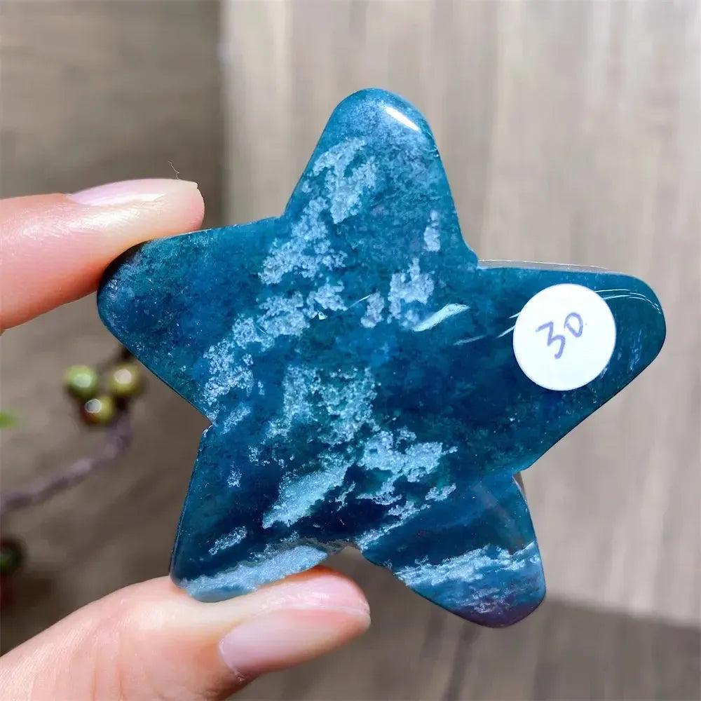 Hand-carved moss agate star crystal from Crystal Destiny, featuring deep blue-green hues and white inclusions.
