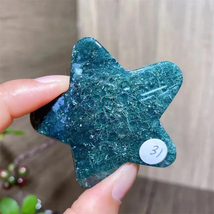 Hand-carved green moss agate star crystal from Crystal Destiny, showcasing deep forest-like inclusions.