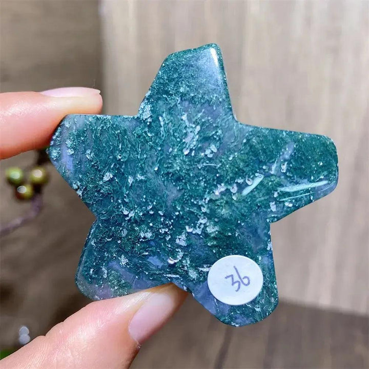 Hand-carved green moss agate star crystal from Crystal Destiny, showing unique forest-like inclusions.