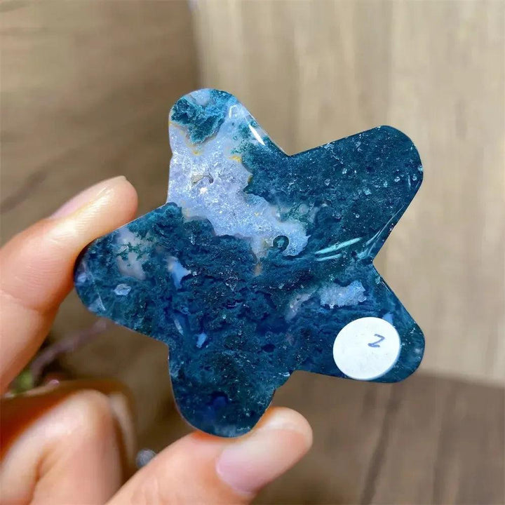 Hand-carved moss agate star crystal from Crystal Destiny, featuring deep green and white inclusions.