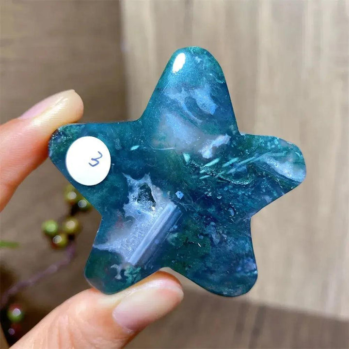 Hand-carved moss agate star crystal from Crystal Destiny, featuring deep green and blue inclusions.
