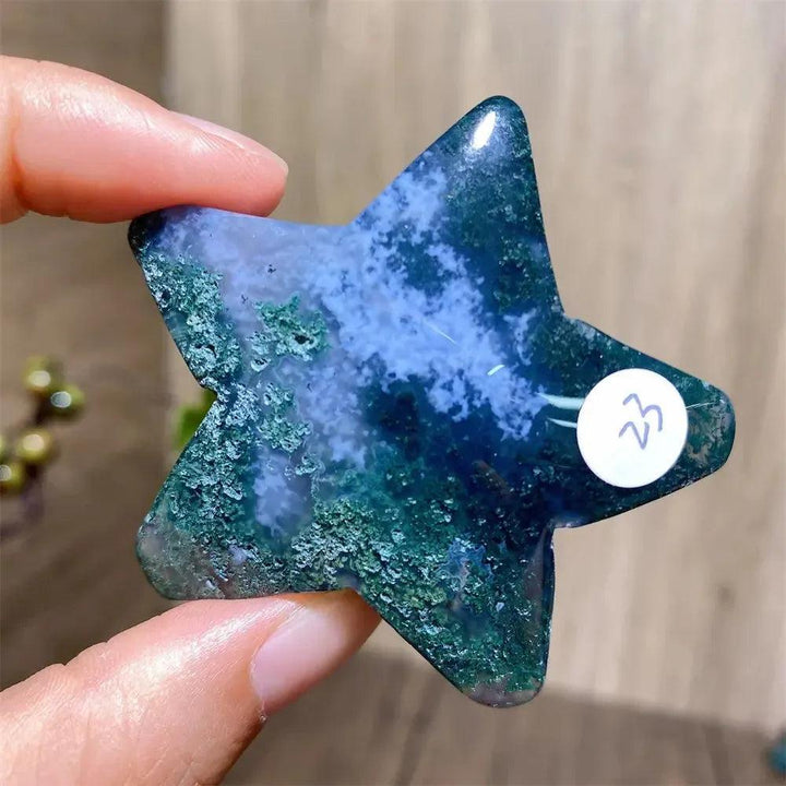 Hand-carved green moss agate star crystal by Crystal Destiny, showing deep green inclusions and blue hues.