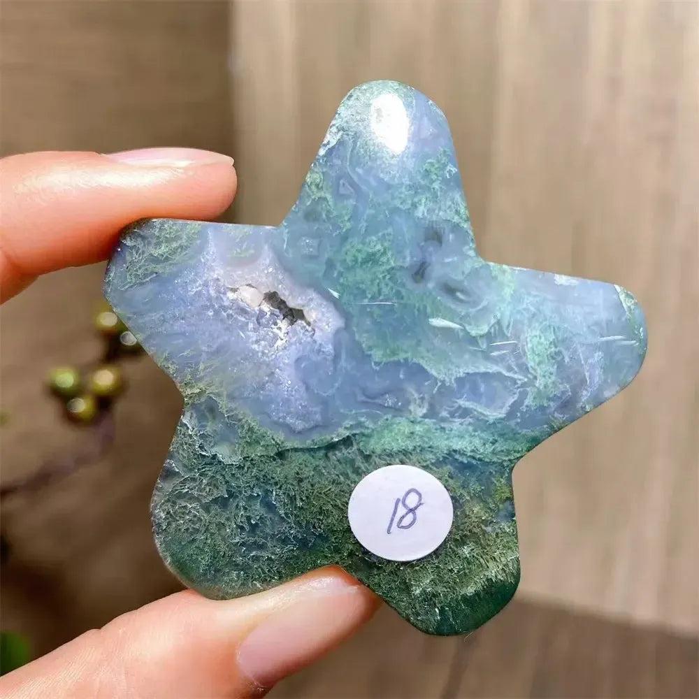 Hand-carved moss agate star crystal from Crystal Destiny, featuring deep green and blue inclusions with a geode center.