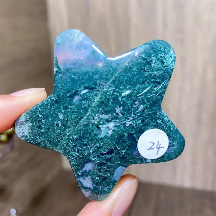 Hand-carved green moss agate star crystal from Crystal Destiny, showcasing deep green inclusions and natural translucency.