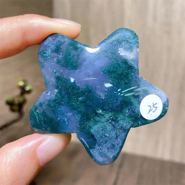 Hand-carved moss agate star crystal from Crystal Destiny, featuring deep green inclusions and a smooth finish.