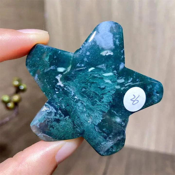 Hand-carved green moss agate star crystal from Crystal Destiny, showcasing deep green inclusions.