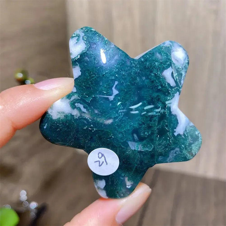 Hand-carved green moss agate star crystal from Crystal Destiny, showcasing unique white inclusions.