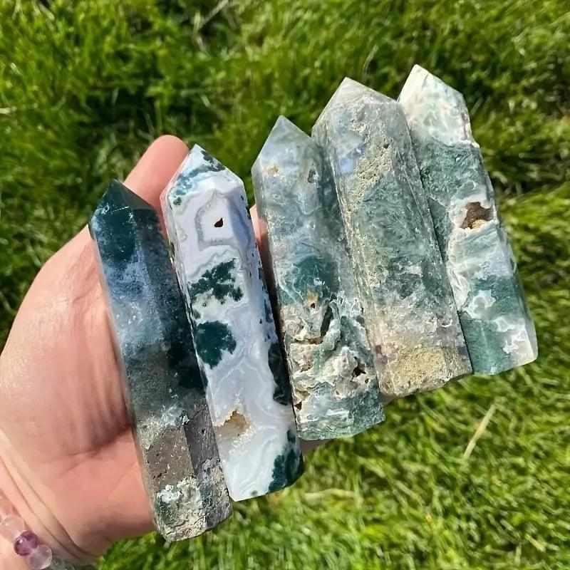 Polished moss agate hexagonal towers featuring green, plant-like inclusions for heart chakra growth and natural beauty.