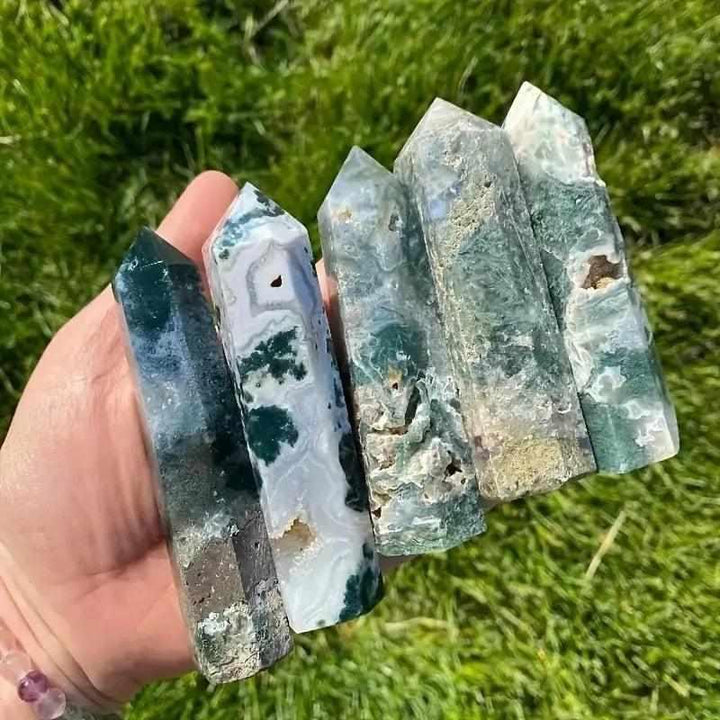Polished moss agate hexagonal towers featuring green, plant-like inclusions for heart chakra growth and natural beauty.