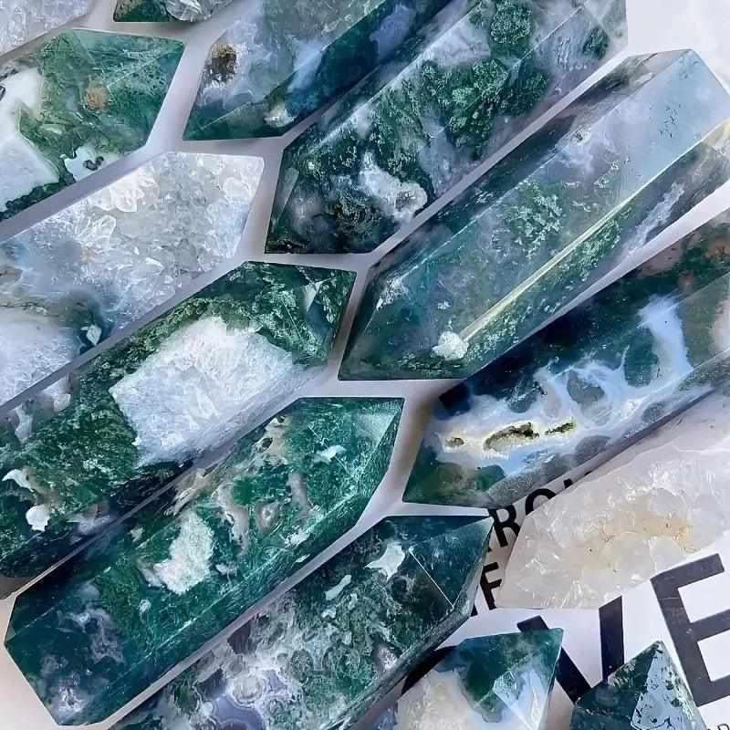 Polished hexagonal Moss Agate towers featuring lush green moss-like inclusions for heart chakra healing and growth.
