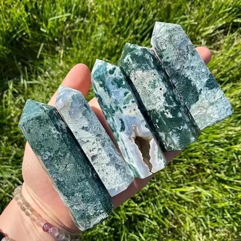 Handheld Moss Agate hexagonal towers featuring lush green plant-like inclusions for heart chakra growth and grounding.